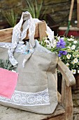 Hand-sewn shopping bag made from beige and pink linen and decorated with lace trim