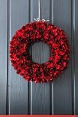 Door wreath of red pinecones and curled wood shavings