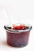 Blackcurrant jam with a spoon in a jar