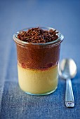 Vanilla and chocolate pudding with redcurrants in a glass