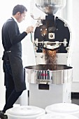 A barista by an industrial coffee machine