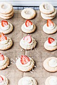 Strawberry biscuits with strips of glacé icing