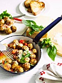 Meatballs with cherry tomatoes and basil