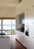 Modern kitchen with white cupboards and sink in central island