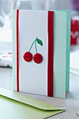 Hand-crafted card decorated with cherries made from red buttons