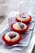 Mini muffins with cherries decorated with ribbon flags