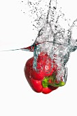 A red pepper falling into water