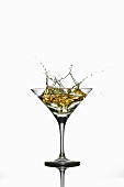 A martini splashing out of a glass