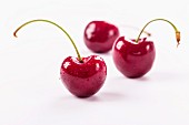 Three cherries with drops of water