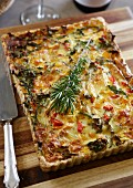 Wholemeal quiche with spinach, onions, peppers and brie cheese