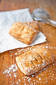 Apple pastries dusted with icing sugar