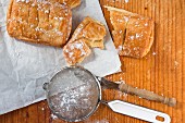 A sieve with icing sugar and apple pastries