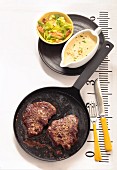 Beef steaks in the pan with bearnaise sauce and a side salad