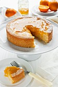 orange cake with sliced removed and fresh oranges