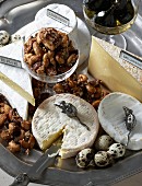 A cheese platter with Brie and Camembert, caramelised nuts and figs in syrup