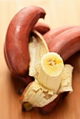 Red bananas, one peeled