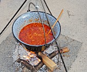 Hungarian bean stew in a pot cooked over an open fire