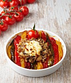 Three colours of pepper, topped with sardines and goat's cheese and baked