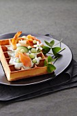 Savoury waffle with salmon, prawns and cucumber