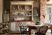 Former, renovated dairy with Shaker-style furnishings - large, old dresser, chest of drawers and wooden armchairs