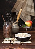 Oats, Flax Seeds and a Pear on a Rustic Wooden Table