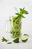 Sliced Kiwi with Mint and Lime in a Pitcher