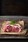New York Strip Steaks on Butchers Paper; Knife