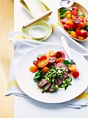 Peppercorn lamb fillets in herb vinaigrette with tomato medley