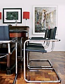 Bauhaus cantilever chairs with black leather seats and backs at antique table in traditional living room