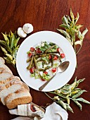 A salad of asparagus tomatoes, feta and bread