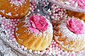 Small Bundt cakes with icing sugar and rose decoration