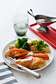 Oven-roasted chicken with apricot stuffing and vegetables