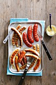 Assorted grilled sausages with mayonnaise (view from above)