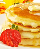 Stack of Pancakes with Butter and Maple Syrup; Strawberry