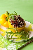 A pepper stuffed with colourful quinoa, sundried tomatoes and olives
