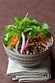 Lentil salad with smoked salmon, rocket and red onions
