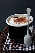 A cappuccino with cream in a mug