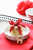 Star-shaped butter biscuits, wrapped and tied with a ribbon, with a wooden moose tree decoration