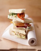 Assorted sandwiches on baking parchment