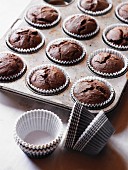 Freshly baked chocolate muffins in a baking tin