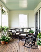 Summer porch with flowers and wicker furniture