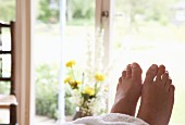 View of feet of woman lying on relaxation couch after massage