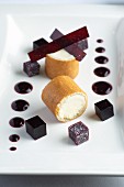 Ice cream roll with blackberry jelly and sauce
