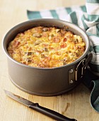 A small vegetable cake with bacon in a spring-form cake tin