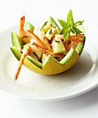 Prawn salad with melon and mint in a hollowed-out melon half