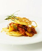 A stack of fried potato slices and ratatouille