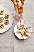Assorted party snacks (mini spinach quiches, cheese straws, satay skewers)