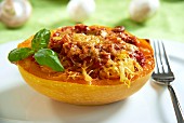 Spaghetti squash filled with tomato sauce and mushrooms, topped with cheese and baked