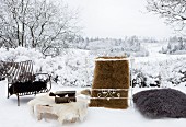 Various animal skins on chairs, table, cushion and as rug in snow