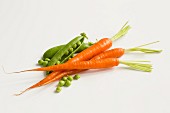 Fresh Peas and Carrots on a White Background